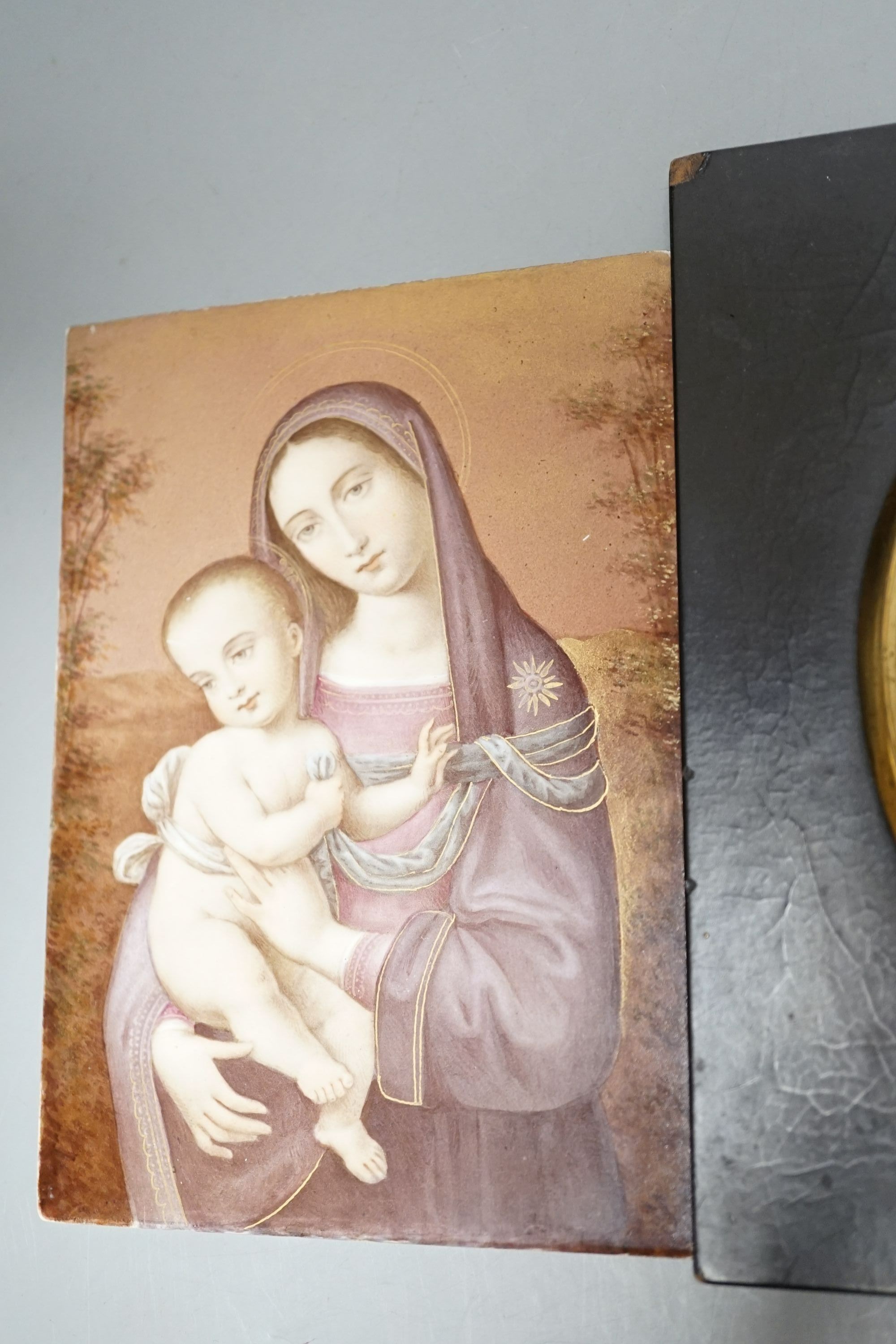 A Limoges style painted pottery plaque - Madonna and child, together with a Victorian reverse painted glass silhouette portrait